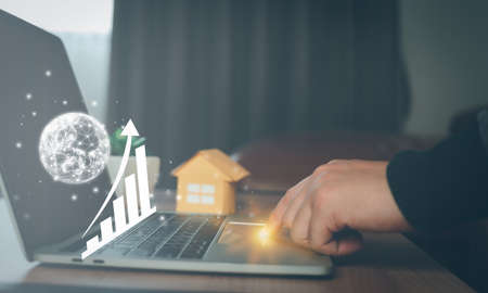 Business  Finance concept. Human using laptop technology for digital marketing of statistics growth up of graph with working home loan mortgage to summary expense payment. Management  goal strategy.の写真素材