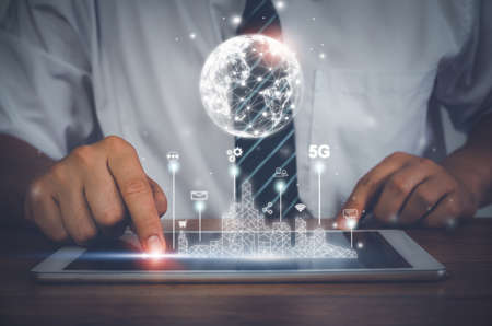 Businessman using tablet technology of global network connection of world. Management  goal strategy. hologram modern virtual screen interface. Business  Finance concept. Business intelligent (BI).の写真素材