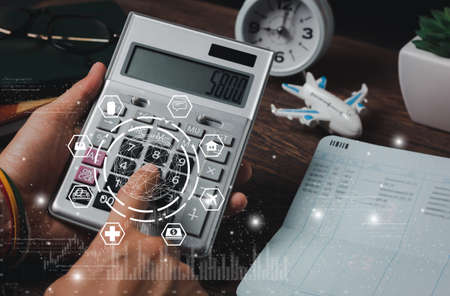 Close up man calculate expense monthly with banking life insurance home loan travelling credit card annual savings money heath care costs growth up chart. Financial and spending payment concept.の写真素材