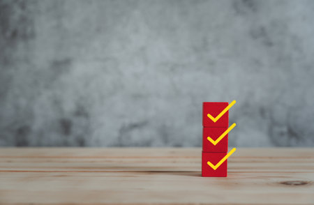 Object on the table of icon sign checklist on wooden block stacking same as step stair up on the blurred grey background, Business mark up concept. copy space for text. Clipboard and check marksの写真素材