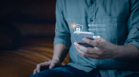 Man using mobile phone Privacy protect data and cybersecurity. Network security  data protection.User login,Protective Personal Data information. Technology cyber Services password on virtual screen.の写真素材