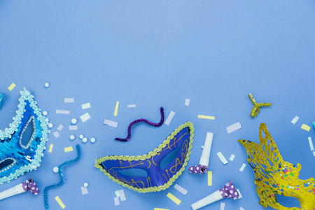 Table top view aerial image of beautiful colorful carnival festival background.Flat lay accessory object the several mask  decor confetti on modern pink paper at home office desk studio.copy space.の写真素材