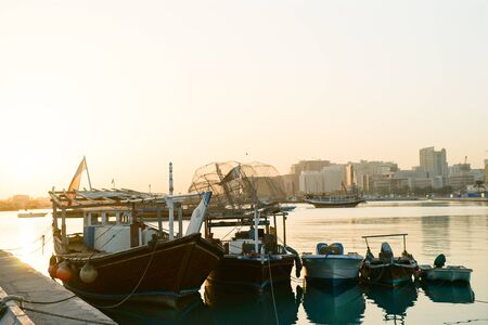 Doha port with boats in early morning sunrise
