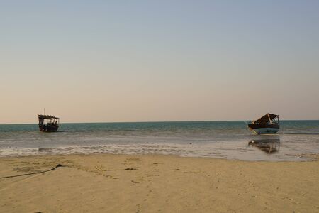 Dhows on beach in Qatar with peaceful sea