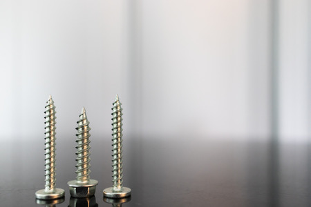 Roofing Screws on black surfaceの写真素材