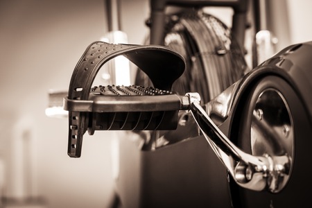 Stationary exercise bike pedals in home gymnasium to keep fit and healthyの写真素材