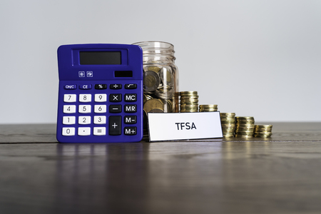 Jar of Coins with calculator showing savings to a Tax Free Savings Accountの写真素材