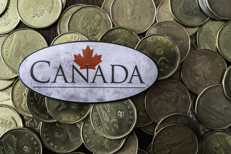 Canadian one dollar coins with a canadian flagの写真素材