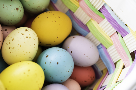 Painted Easter Eggs in brightly colored basketの写真素材