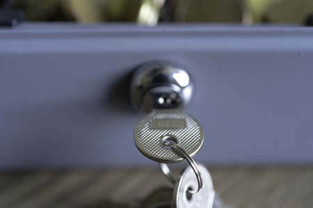 Cashbox lock with keys and full of Coinsの写真素材