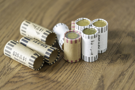 February 17 2019 - Calgary, Alberta Cananda - Stacks of coins rolled up for easy countingのeditorial素材