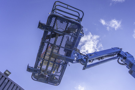 Cherry Picker Crane Underneath blue clear skiesの写真素材