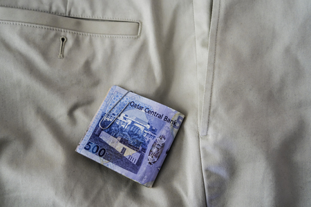Qatari Riyal notes falling out of trouser or Pants Pocketsの写真素材