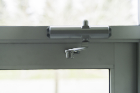 Door Closer on Glass door on building entraceの写真素材