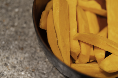 Slices of Raw Fresh Sweet Potatoes ready to cookの写真素材