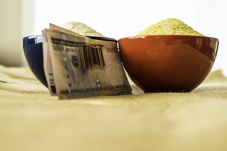 Nigerian yellow and white Garri in Bowls at marketplace