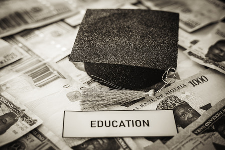 University Mortarboard academic cap on Nigerian Naira notes