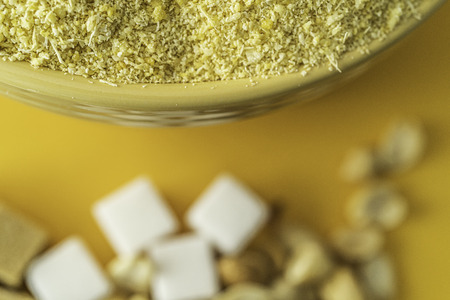 Bowl of Nigerian Yellow Garri in Yellow bowl with Peanuts and Sugarの写真素材