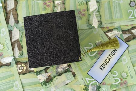 University Mortarboard academic cap on Canadian Dollar notesの写真素材