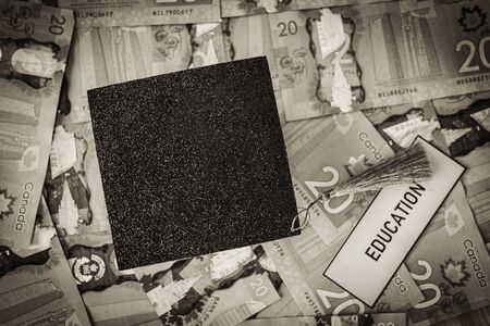 University Mortarboard academic cap on Canadian Dollar notesの写真素材