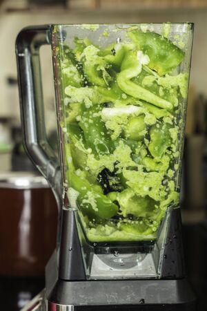 Green Bell Peppers blended to prepare Spicy Nigerian Ofada Stewの写真素材