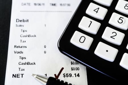 Reconciling Credit Card batch report with receipts at end of the dayの写真素材