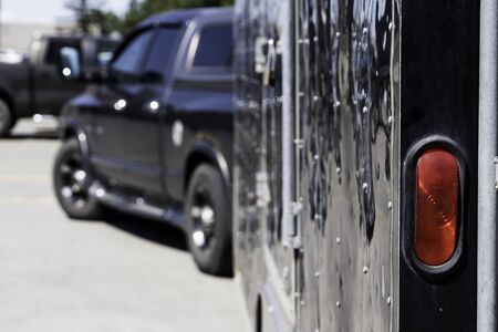 Trailer being pulled by a truck in industrial parking lot