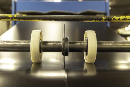 Roll of sheet metal being sliced cut into 2の写真素材