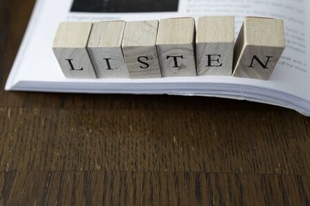 LISTEN in Block Letter on an open book - Listening to an Audio book