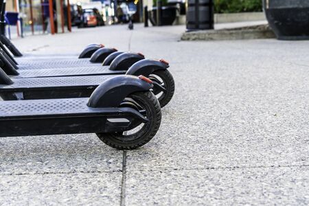 Electric Scooter wheels on a city pavement - Ride Sharing and rentals