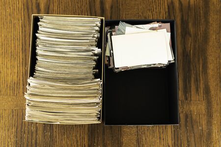 Stack of old photo prints and Memories to be digitized a