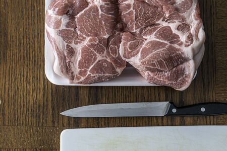 Pork shoulder ready to be cut to prepare stew and soupの写真素材