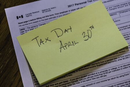 Sticky Note on Canadian Tax Form to show Canada Tax Dayの写真素材