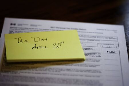Sticky Note on Canadian Tax Form to show Canada Tax Dayの写真素材