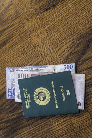 Nigerian Passport with Saudi Riyal Banknotesの写真素材
