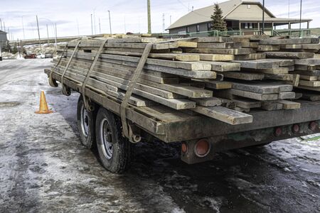 Pile of Wood on trailer bed to be used for contruction siteの写真素材