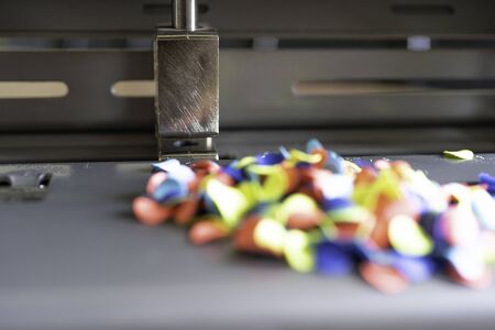 Paper Chads produced by punching holes in a sheets of colored paper