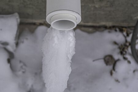 Furnace exhaust vent with Icicle from dripping water in winter
