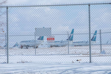 April 11 2020 - Calgary , Alberta, Canada - Airliners parked at the Calgary International Airport -...