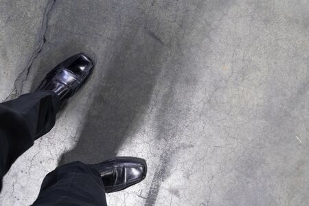 Man standing with polished Shoes on concrete floorの写真素材