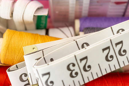 Measuring tape with collection of sewing items used by a seamstress to make clothesの写真素材