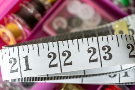 Measuring tape with collection of sewing items used by a seamstress to make clothesの写真素材
