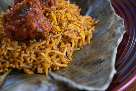 Nigerian Spicy Jollof rice served on a leafの写真素材