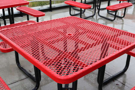 Outdoor furniture with raindrops outside fast food restaurant