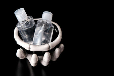 Skeleton claw holding bowl with Hand Sanitizer for Halloweenの写真素材