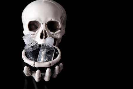 Skeleton Skull with Hand Sanitizer bottles for covid 19の写真素材