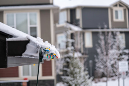 Christmas Lights hanging on roof of houseの写真素材