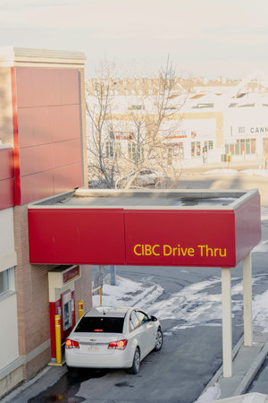 January 16 2021 - Calgary , Alberta Canada - Customer withdrawing cash from drive thru atm machineのeditorial素材