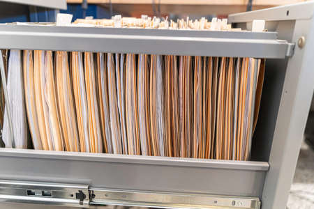 Hanging files in filling cabinet in an officeの写真素材