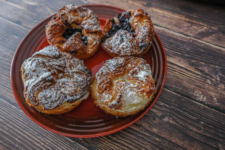 Danish sweet pastrys on a red plateの写真素材